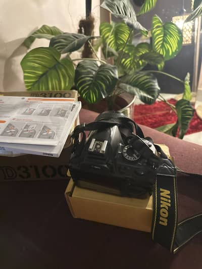 Nikon D3100 DSLR box with accessories.