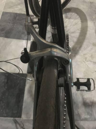 Racing cycle with four brakes