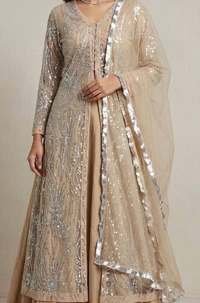 Beautiful beige 3 piece lehnga set with Heavy net jacket and dupatta .