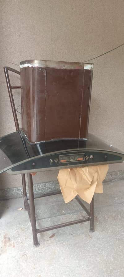 Wall-mounted black glass kitchen exhaust hood