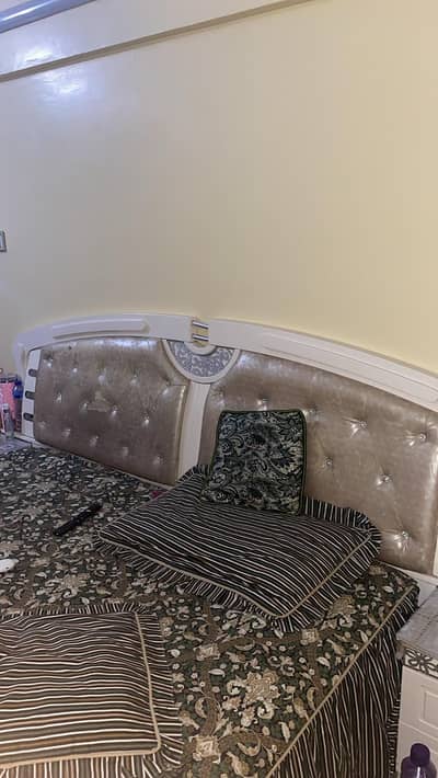 Off-white bed with two side tables