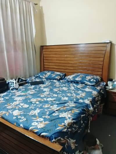 wooden King size bed with one side table.