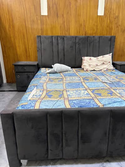 king size bed with side table and dressing tabem
