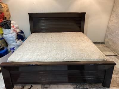 Double bed with 10 inch spring mattress. Tow  side table with dressing