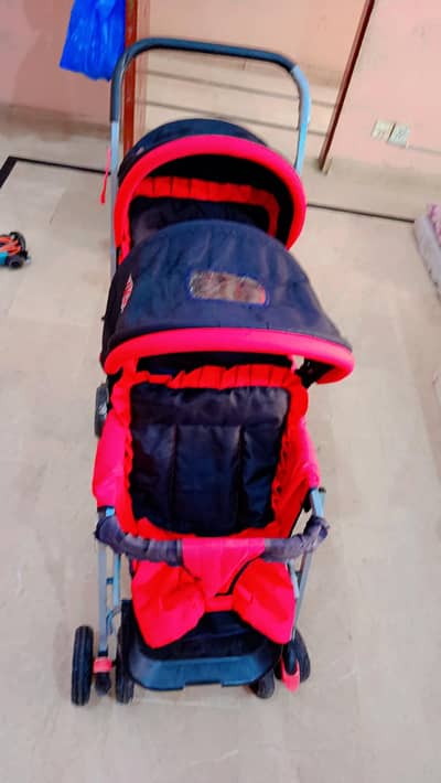 twin baby stroller in a black and red color
