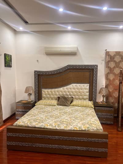 King bed with two sidetables and dressing table.