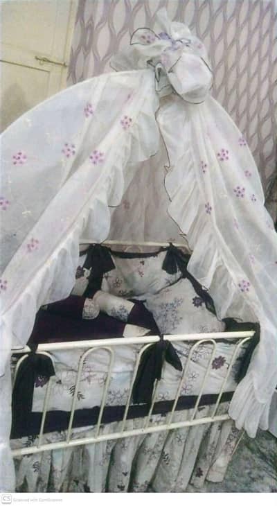 Baby cot with bedding