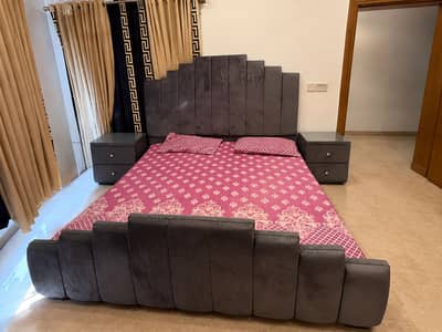 Slightly used upholstered bed with side tables and mattress