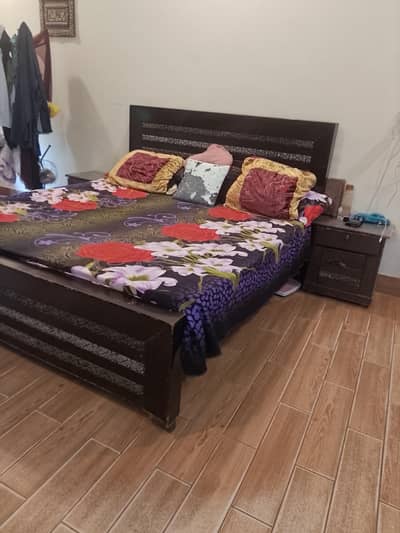 king size bed with two side tables and  dressing