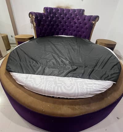King sized round bed with side tables and mattress.