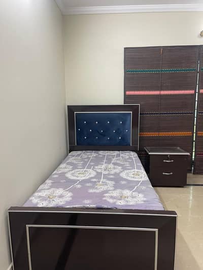 single bed with one side table