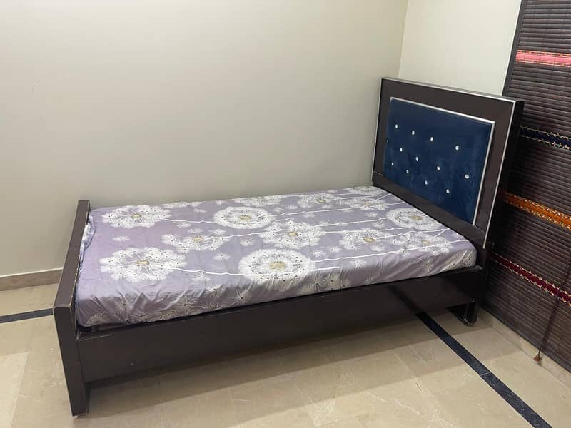 single bed with one side table 4