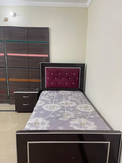 single bed with one side table