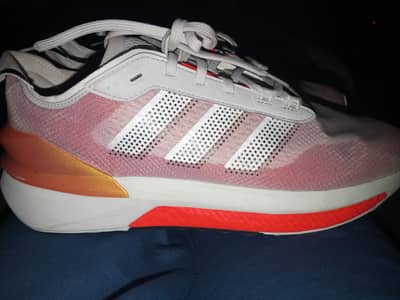 adidas Avryn Shoes in a pink, grey, and solar red colorway.