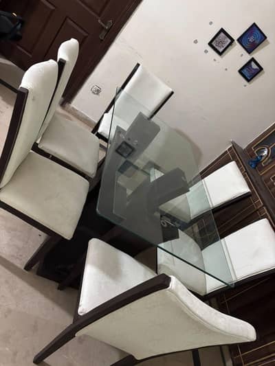 Six seater glass top dining table with six chairs good condition