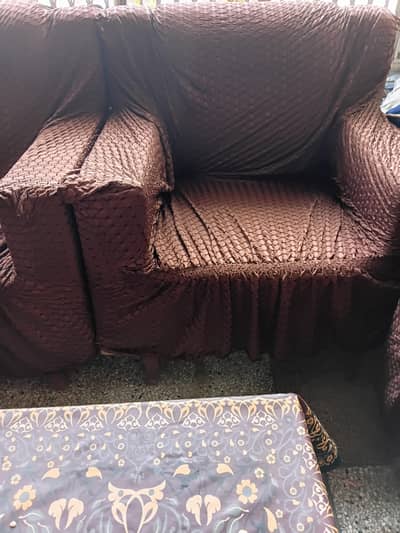 5 seater sofa with sofa covers and wooden table included