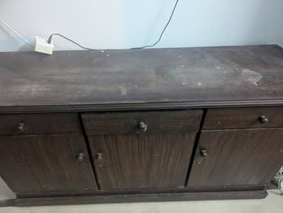 brown wood table with drawers and cabinets