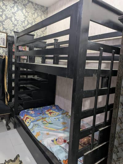 I am selling bed it's colour is black and it's bunk bed