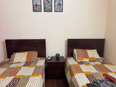 2 single beds one side table