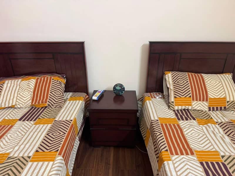2 single beds one side table 2