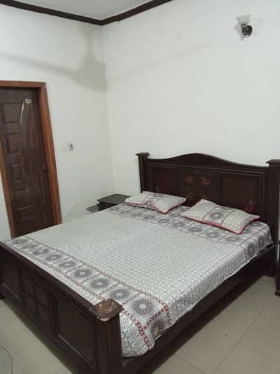 Double bed with spring mattress & side tables.