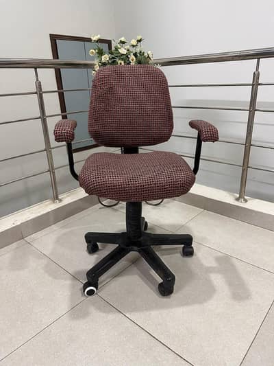 Comfortable maroon revolving office chair