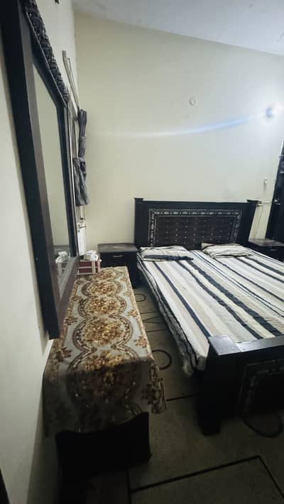 Bed with side table and dressing table
