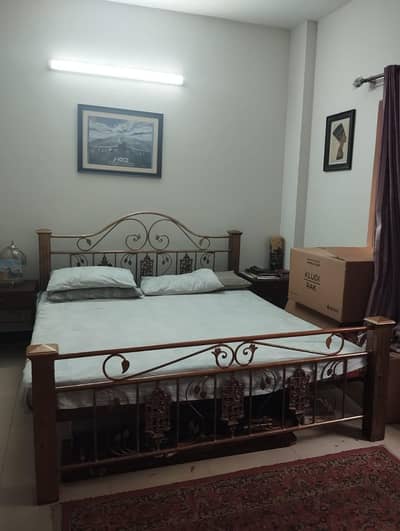 wrought iron king size bed with 2 side tables and dressing table