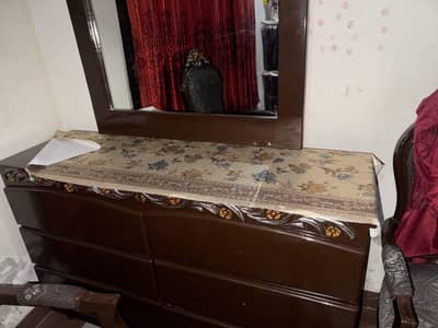 wooden bed with dressing and side table