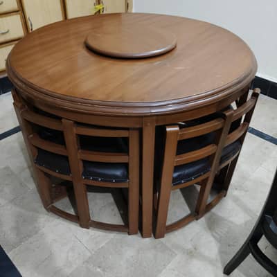 Complete Wooden dining table with rotating top and 6 chairs.