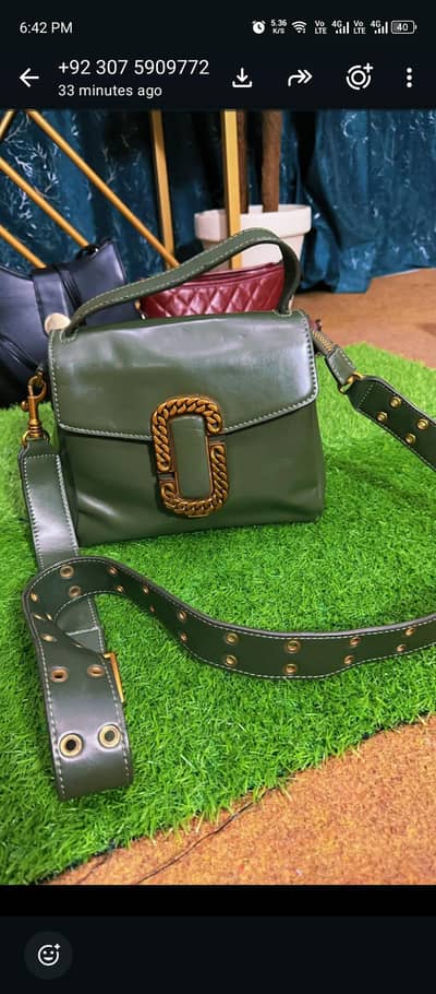 This is an original Cross body bag in olive green color by Mrc Jacob's