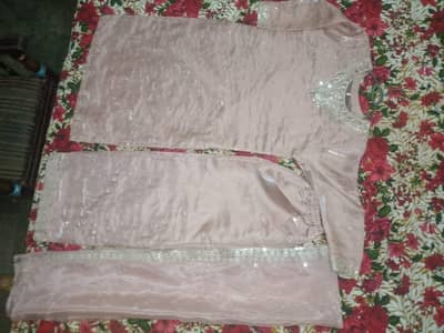peach pink formal dress with golden sitara work.