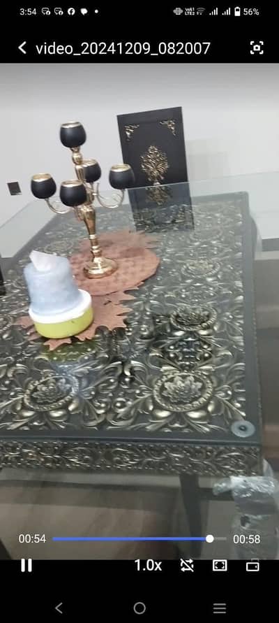 a very classy and good as new dining table of glass and wood