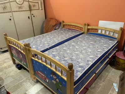 Two kids beds with side table