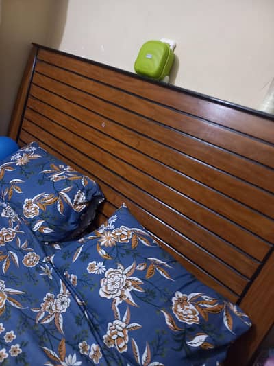wooden King size bed with one side table.