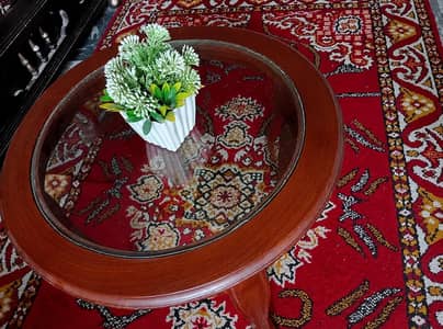 2 carved wooden chairs with matching wooden table