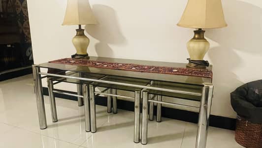 Glass center table with three glass side tables.