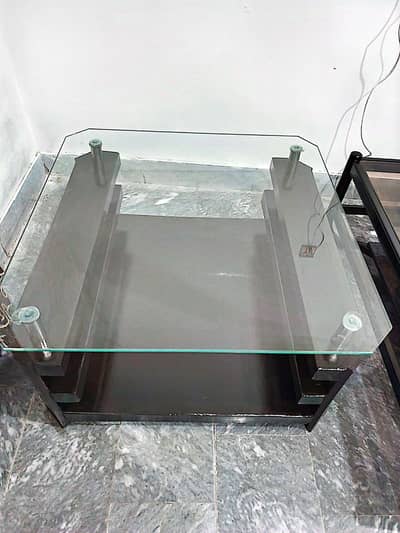 modern glass  coffee center table with a dark wooden brown base