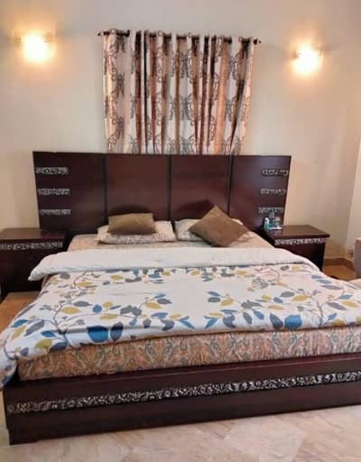 king bed with mattress along with two side tables and a dresser