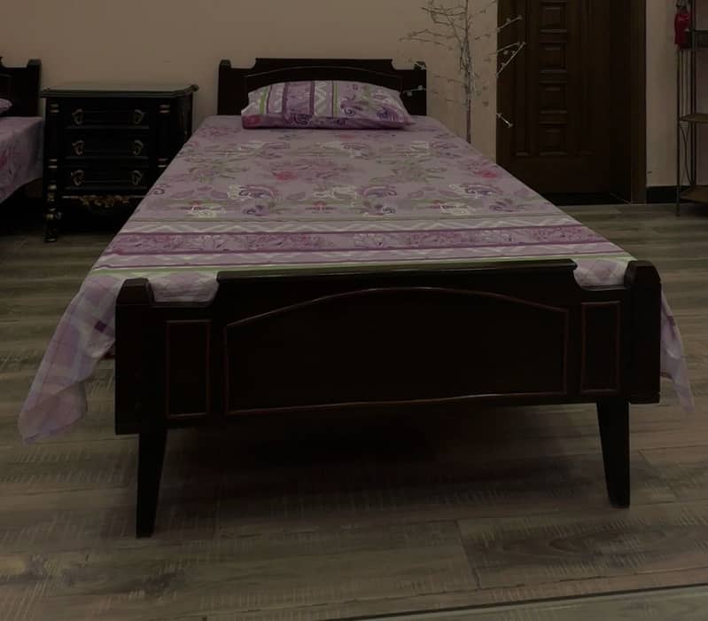 2 single beds and bedside table 1