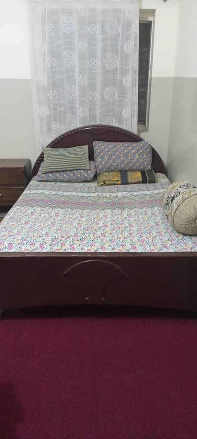 wooden bed with mattress