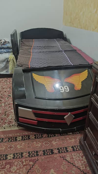 A car theme single bed and matching book rack for boys