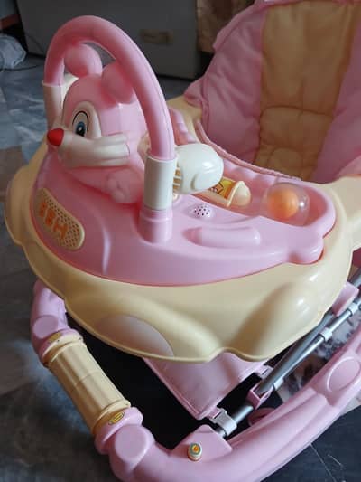 Baby walkerwith parent handle pink in colour