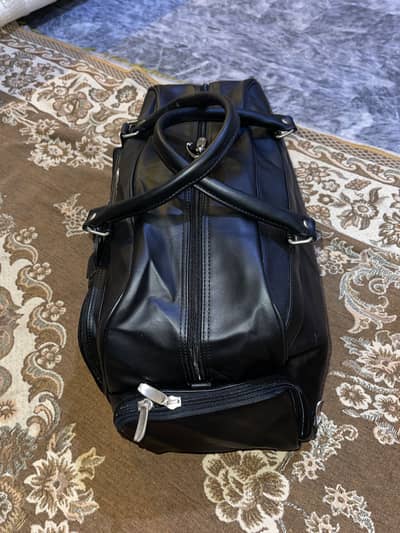 black Mercedes-Benz travel duffel bag
