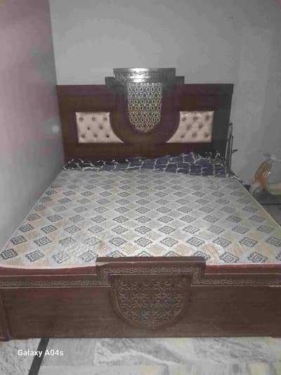 One double bed with mattress, three door Almirah and dressing table