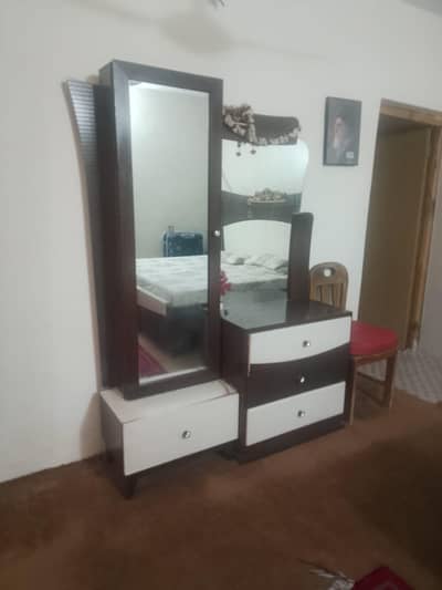 double bed with side tables, dressing table and showcase