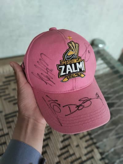 cap sign by Babar Azam and Haris and other player sign