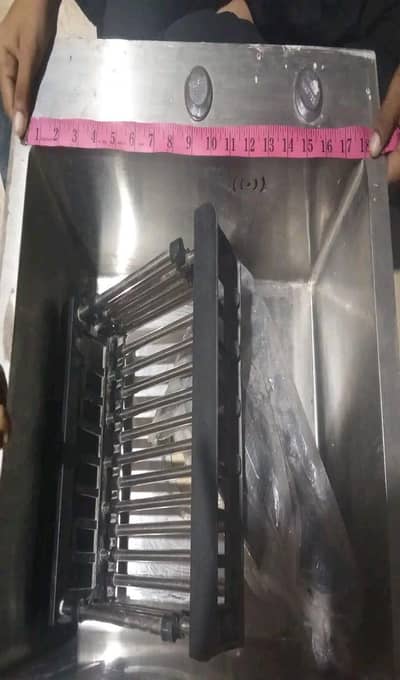 kitchen sink with basket and drainage pipe