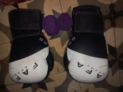 Black Everlast punching bag with gloves and hand wraps