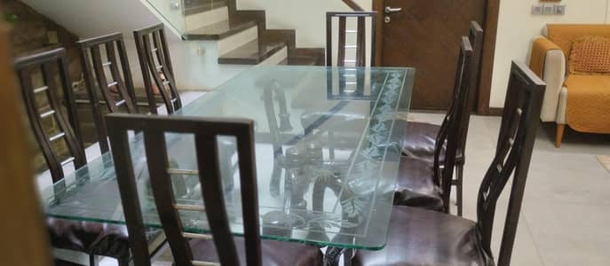 woden dinning table with glass with 8 chairs